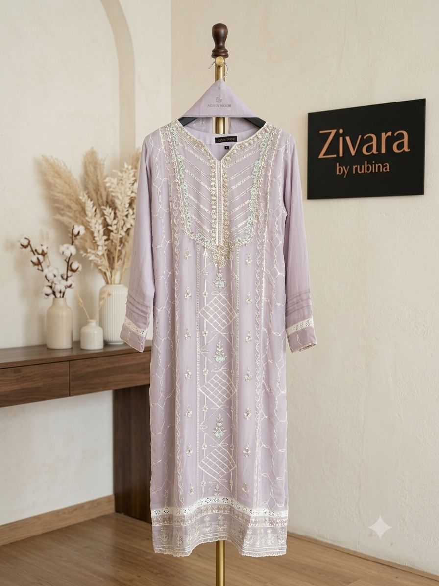 A lavender embroidered kurta on display beside the Zivara by Rubina nameplate in the studio